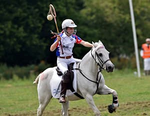 Polocrosse players in action